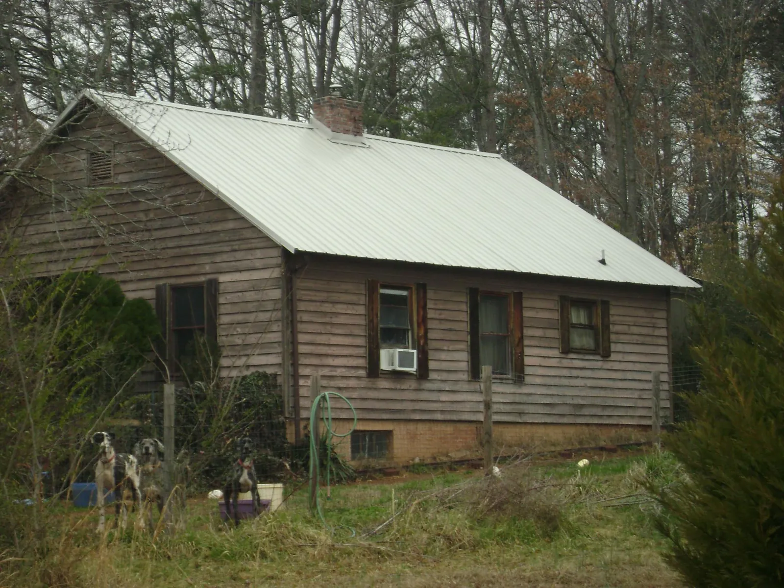 White metal roof on an old wood sided farmhouse, from a Metal Roof Installation job in Elmhurst